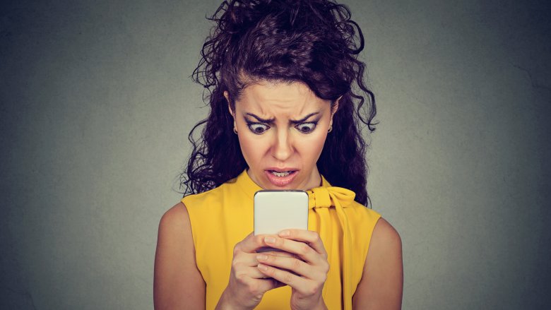 Woman starring at Mobile Phone